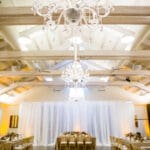 Wedding reception at Solage Calistoga in the Solstice room with Crystal chandeliers over dance floor, pattern wash over dance floor, and sheer white drape for grand entrance.