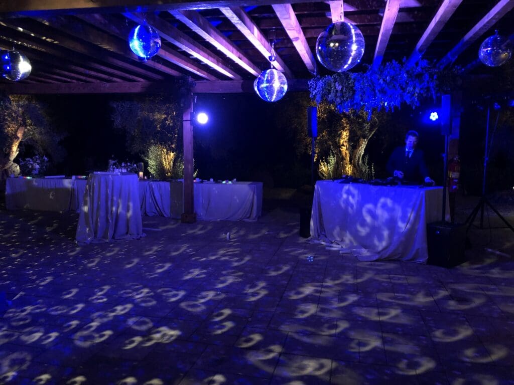 Wedding dance party with disco balls lit with blue and purple color hues.