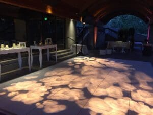 Wedding reception at Domaine Chandon with a rose floral pattern wash over dance floor.